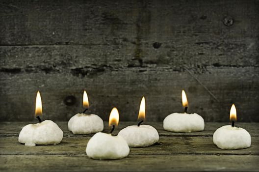 six candles on wooden background