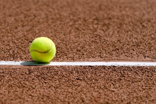 a tennis ball on the white line,