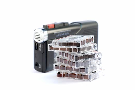 dictaphone on white backgrounds with a stack of records