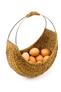 Woven basket full of eggs isolated on white