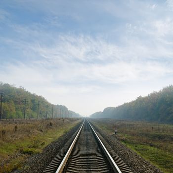 railway goes to horizon in fog