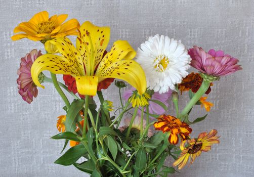 A bouquet of garden flowers on the background of an old linen canvas. August, the Central Russia