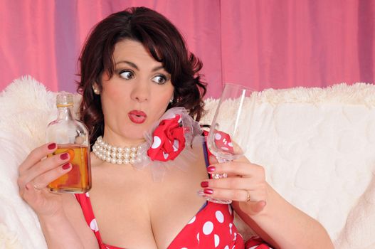 woman pin-up in red dress with bottle whiskey