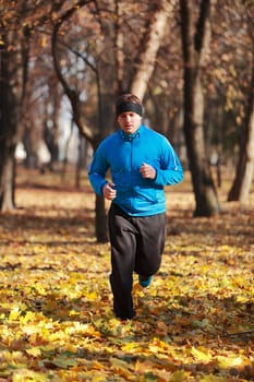 Man running in a forest in autumn.