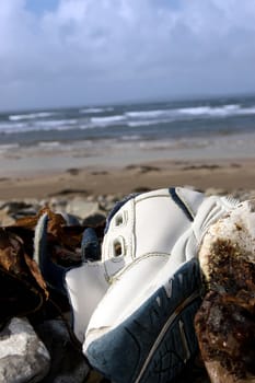 a single shoe washed up on the beach in ireland