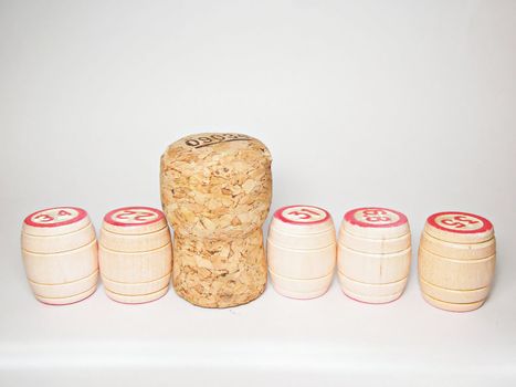 Small kegs with red numbers and brown cork isolated on white background