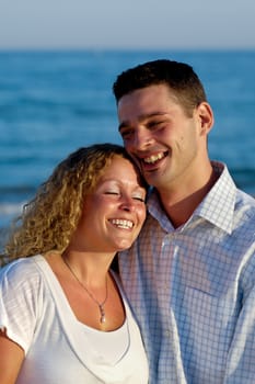 A happy woman and man in love at beach.