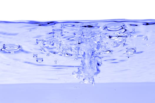 Blue water with air bubbles in the water line. 