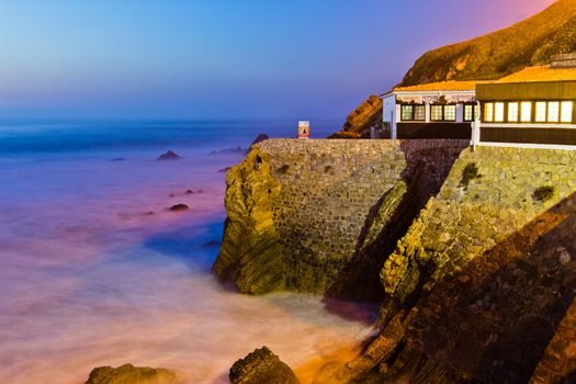 Restaurant on a cliff on sunset in São Pedro de Moel, Portugal