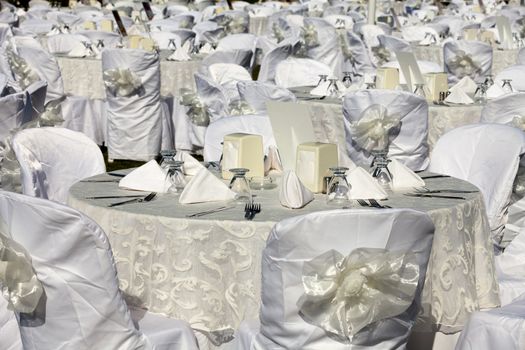 Empty served restaurant table with white tablecloth 