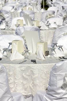 Empty served restaurant table with white tablecloth 