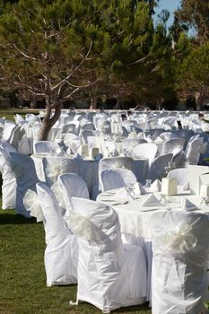 Empty served restaurant table with white tablecloth 