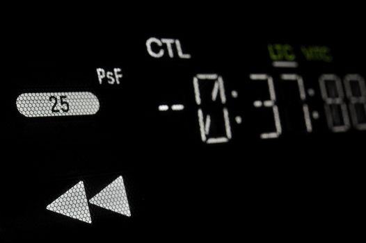 Perspective macro shot of the display of the professional hdcam video player. 
Shallow dof. Visible data: fast backward arrows, timecode, 25 psf, CTL, LTC, VITC