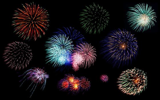 Collection of colorful festive fireworks sparklers salute and petards explosions isolated over black night sky background as design elements