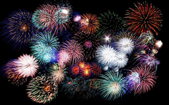 Colorful festive fireworks sparklers salute and petards explosions isolated over black night sky background