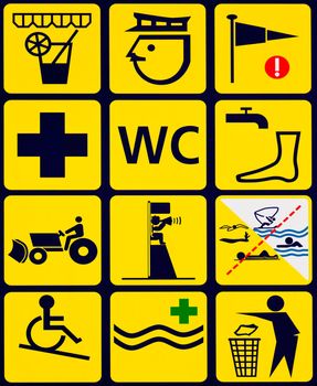 Sign with 12 instructional symbols black on yellow for popular ocean beach swimming