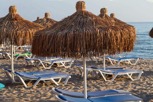 Beach loungers and umbrellas on the sea.