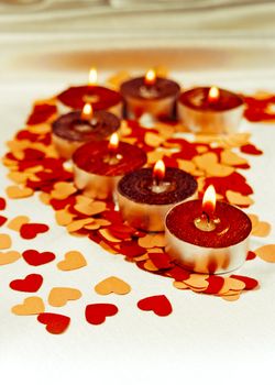 Burning candles heart shaped on a light background. Shallow depth of field.