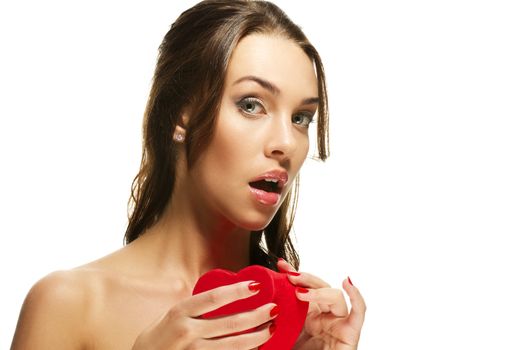 beautiful woman about to open a red heart shaped box on white background