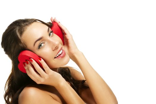 happy woman holding red heart shaped box on her ears on white background