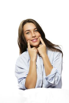 woman in bed forcing herself to smile on white background