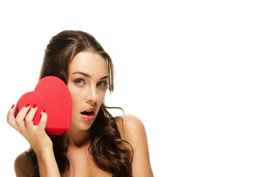 beautiful surprised woman with a red heart on white background