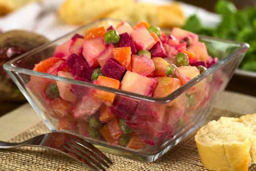 Russian beetroot salad made of beetroot, potato, carrot, pea and a mayonnaise dressing (Selective Focus, Focus one third into the bowl) 