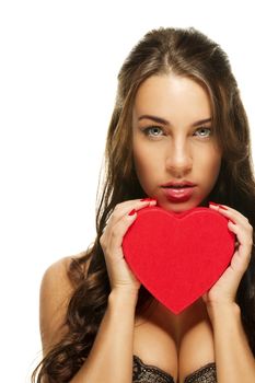 gorgeous brunette woman holding red heart on white background