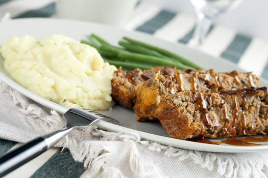 Vegetarian lentil loaf and gravy with mashed potatoes and green beans.