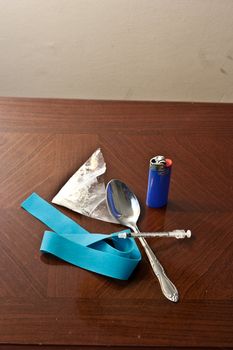 White powder drug with syinge, spoon, and tie off ready to be put to use vertical