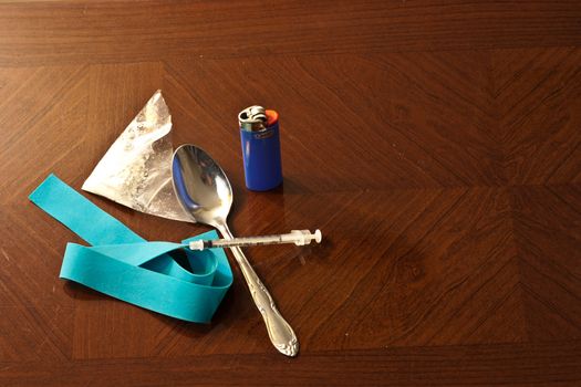 White powder drug with syinge, spoon, and tie off ready to be put to use.