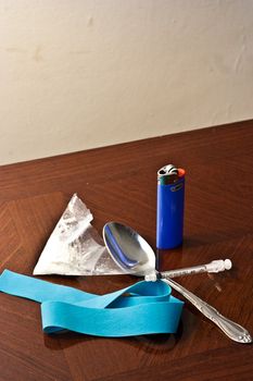 White powder drug with syinge, spoon, and tie off ready to be put to use vertical
