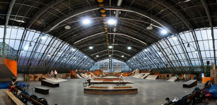 Skate park symmetric horisontal panoramic interior with bike riders