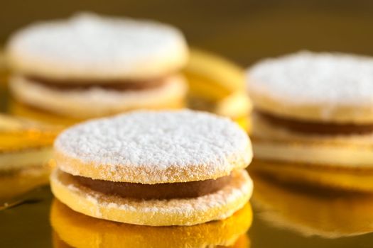 Peruvian cookies called alfajores filled with a caramel-like cream called manjar (Selective Focus, Focus on front upper edge of the first cookie)