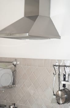 detail of a modern kitchen with modern metallic cooker hood 