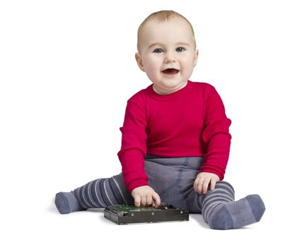 young child in white background with hard drive. red shirt and blue trousers