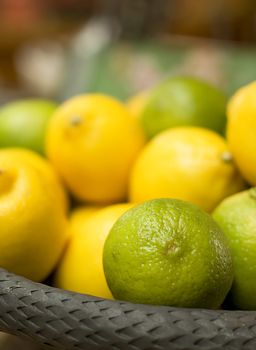 Basket full with green and yellow citrus fruits