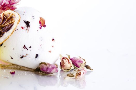 perfume with air-dried flowers on white