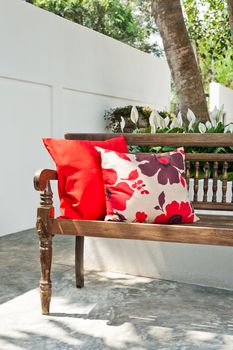 Outdoor patio seating area with nice bench at sunset