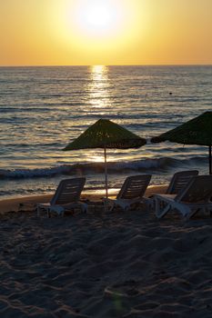 Beach loungers and umbrellas on the sea.