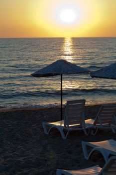 Beach loungers and umbrellas on the sea.