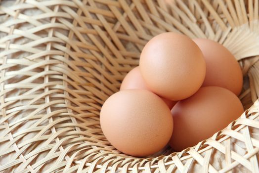 A wicker basket full of brown free range eggs