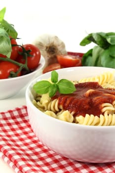 cooked pasta with tomato sauce and basil