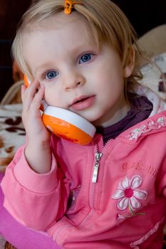 Little girl talking on toy phone