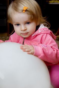 Baby girl playing with big ball