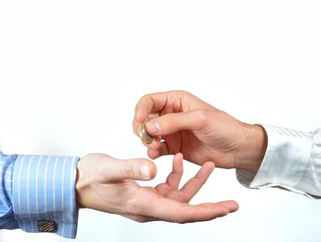 Hands exchanging one euro coin for payment or donation