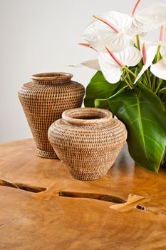 Vases and flowers as interior decoration on wooden table