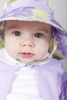 5 Months old Baby giving tranquil look in to lens with her complimenting clothing