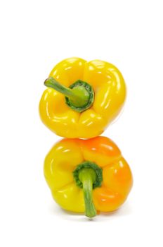 Two yellow bell peppers on white background