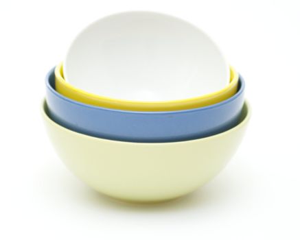 Green, blue, yellow and white plates on white background